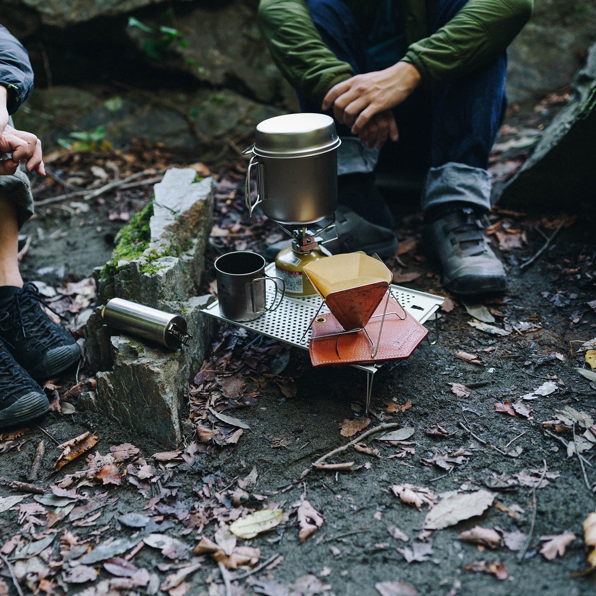 Snow Peak Ozen Solo Table scale with hand showing lightweight size for backpacking benefit