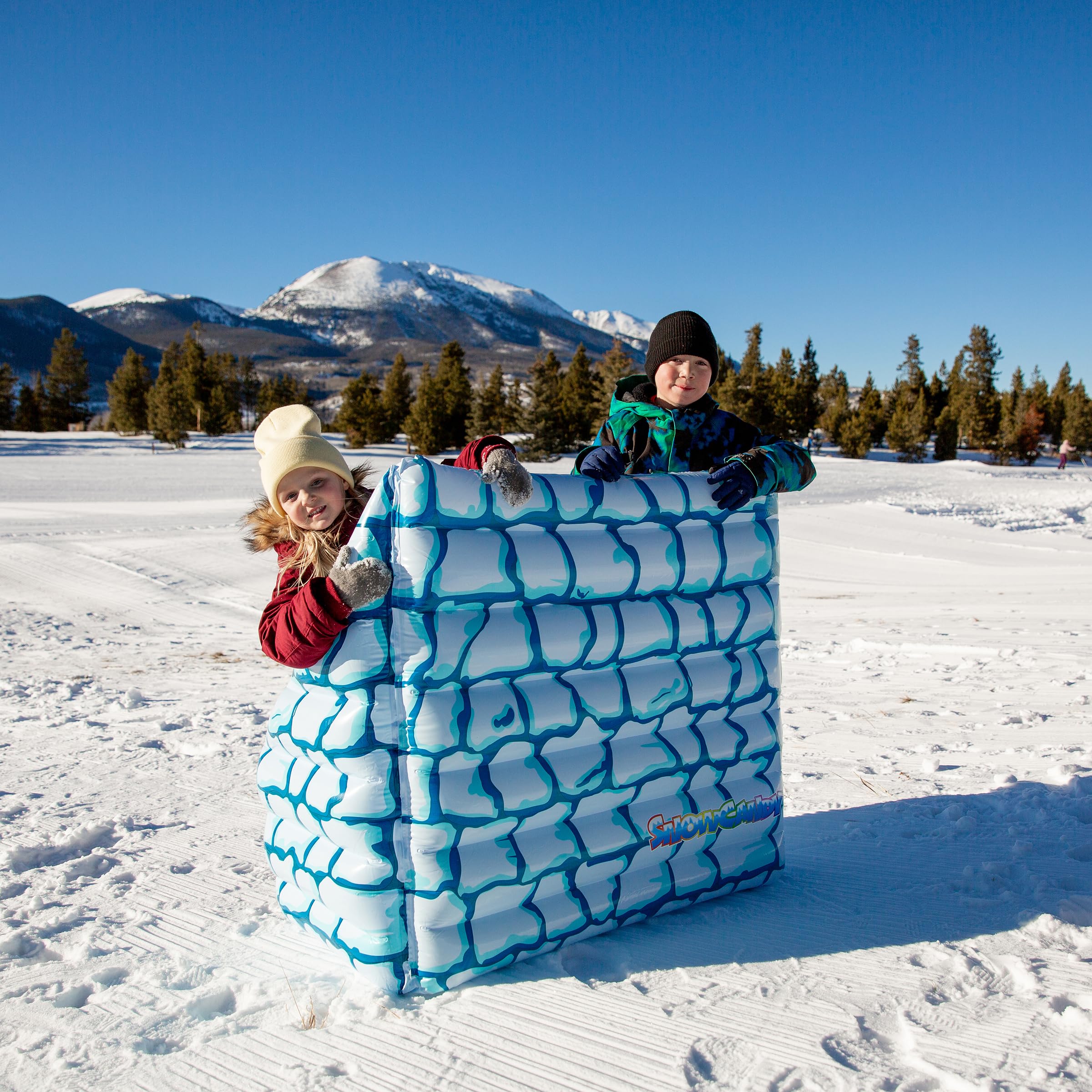 SNOWCANDY children playing behind inflatable bunker illustrating fun and safe snowball defense