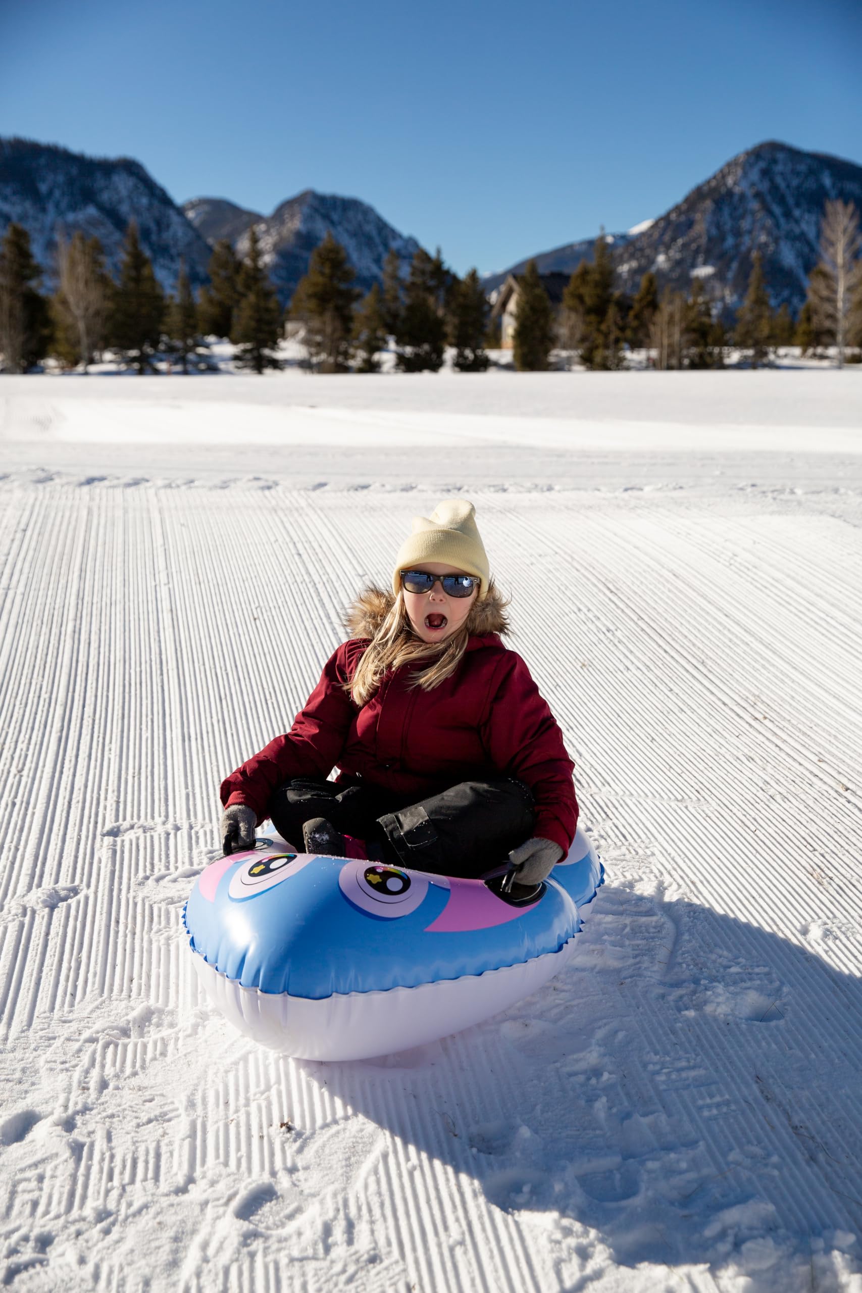 SNOWCANDY child riding sled enjoying safe winter fun