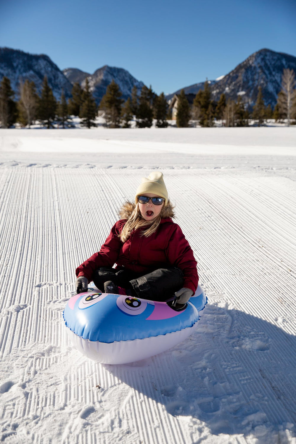 SNOWCANDY child riding sled enjoying safe winter fun