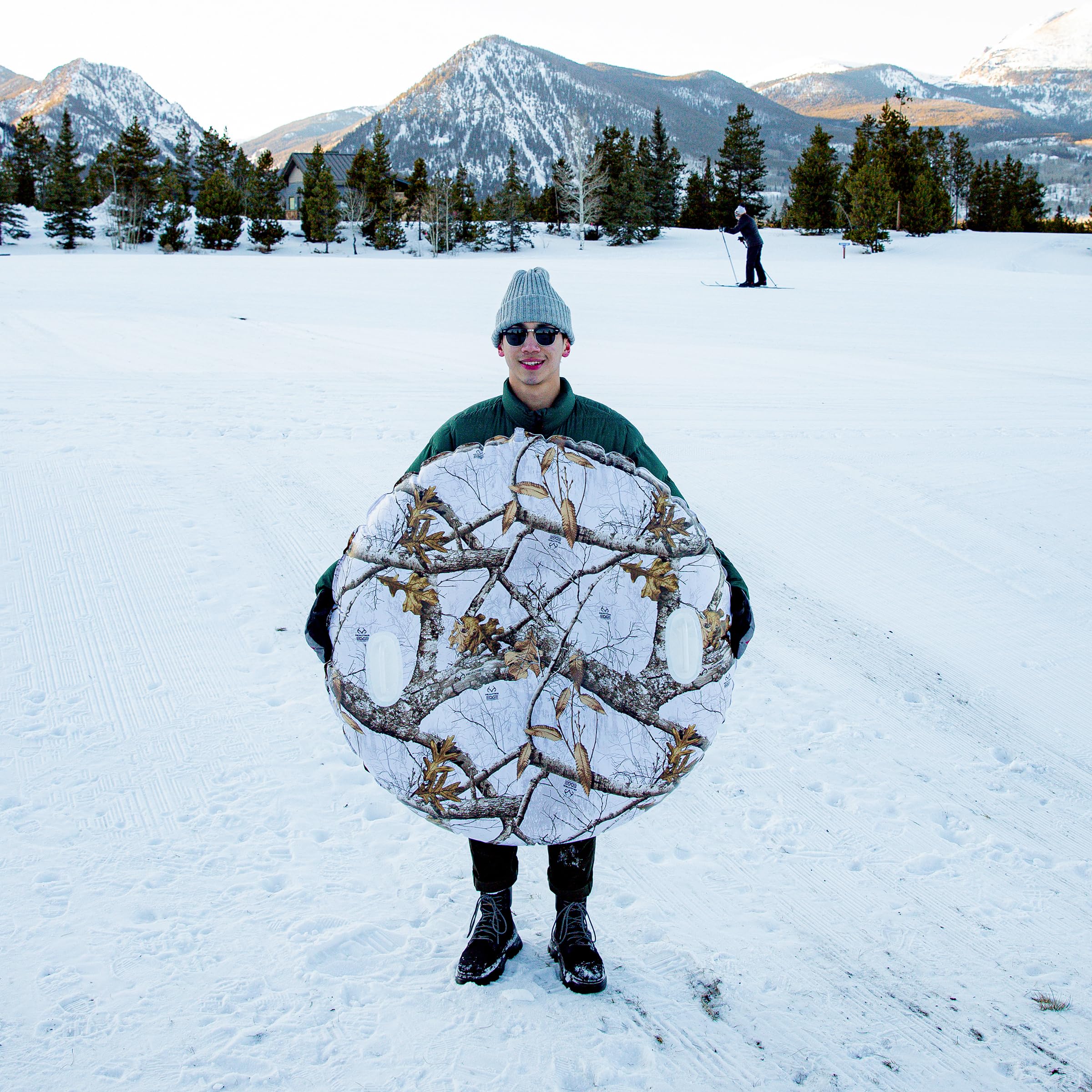 SNOWCANDY inflated tube beside person illustrating 46" jumbo size and stability