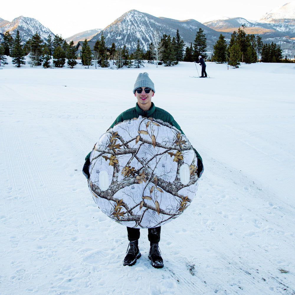 SNOWCANDY inflated tube beside person illustrating 46" jumbo size and stability