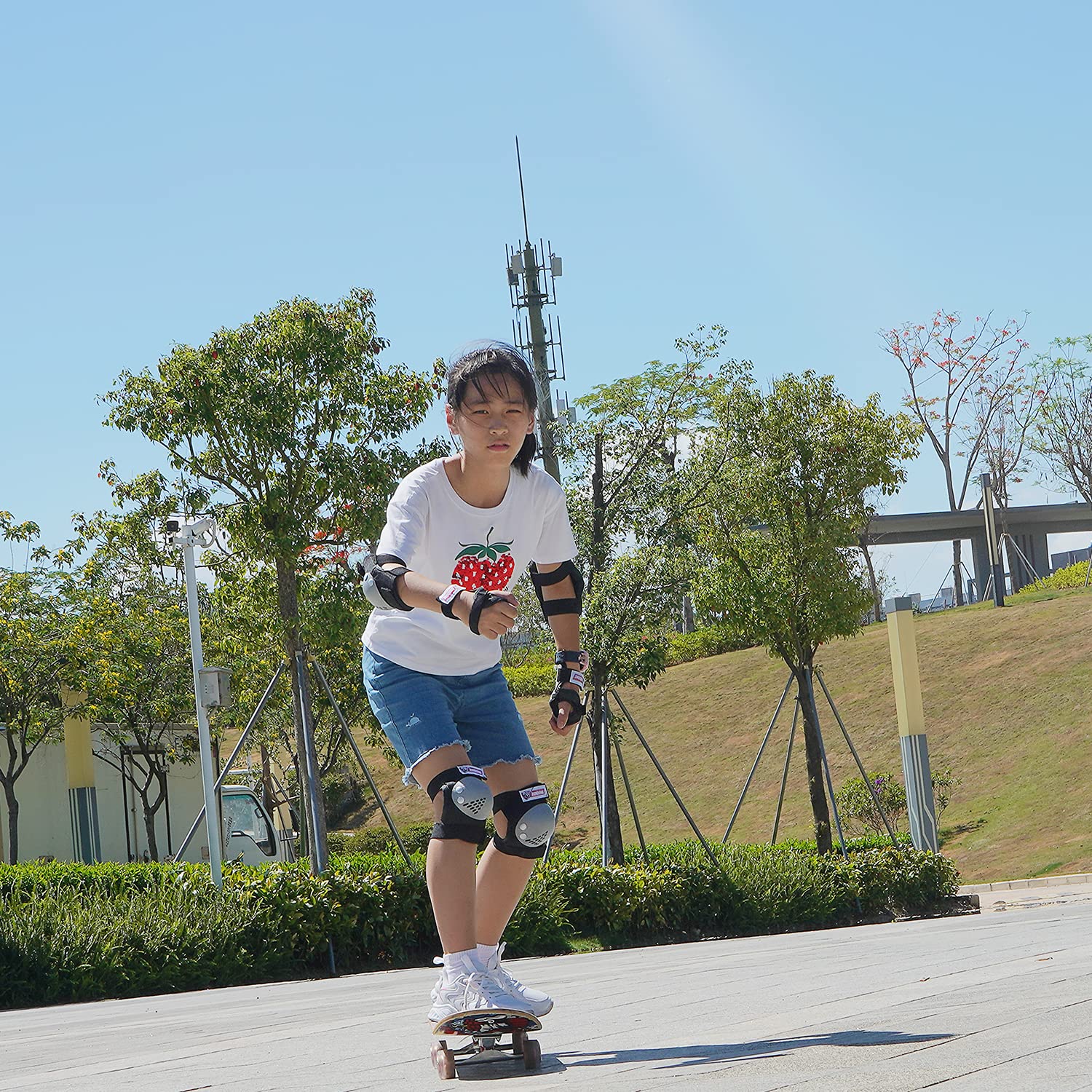 SOHOUR HOME lifestyle image of child riding scooter in park wearing full protective set