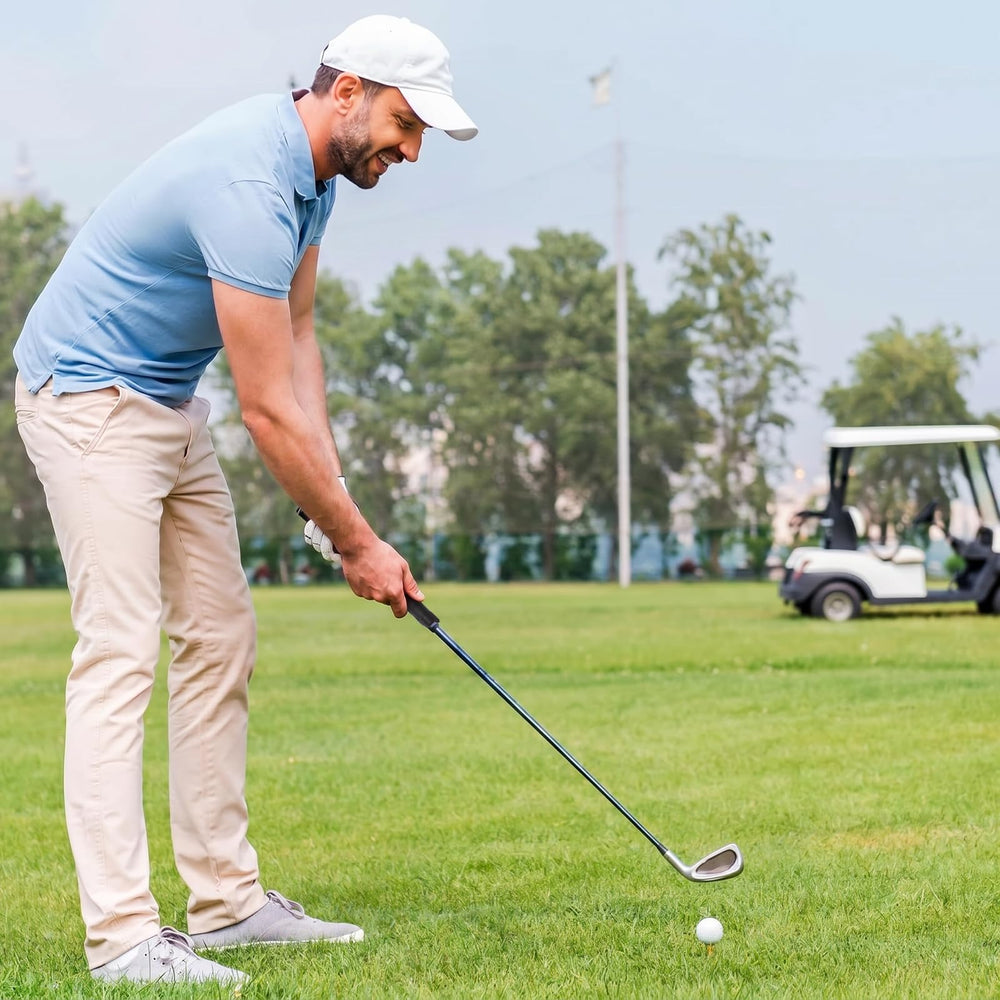 Golfer using Soulchen trainer at driving range to develop consistent muscle memory
