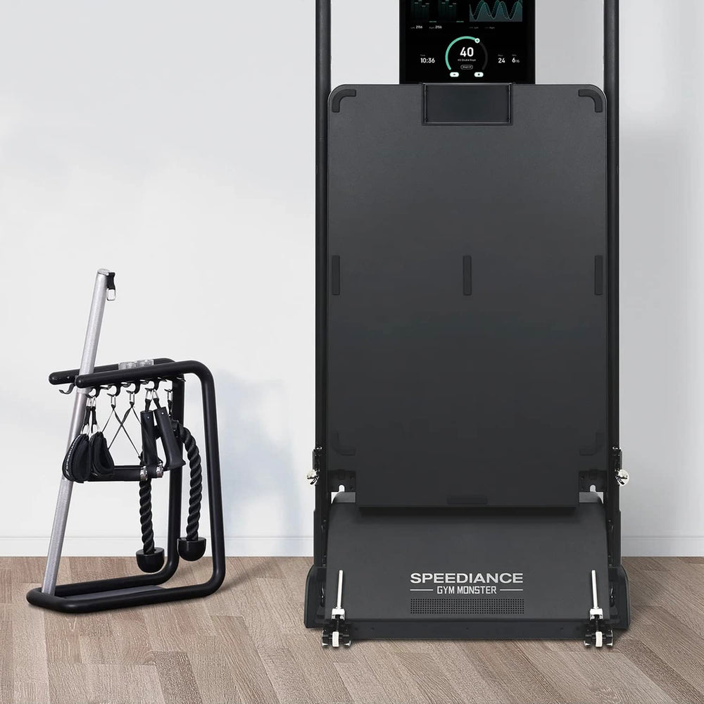Speediance size comparison next to dumbbell showing compact footprint and space saving