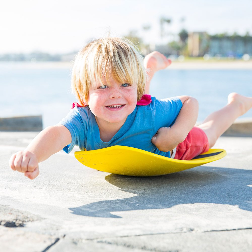 Spooner Boards Freestyle blue next to shoe to show 24-inch size and portability