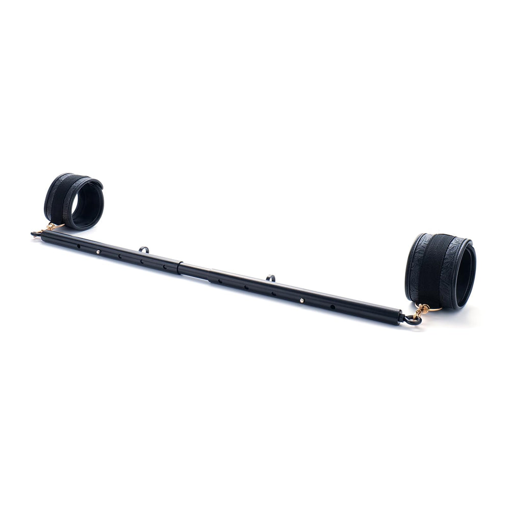 Spreader Bar beside hand showing scale and lightweight 700g portability benefit
