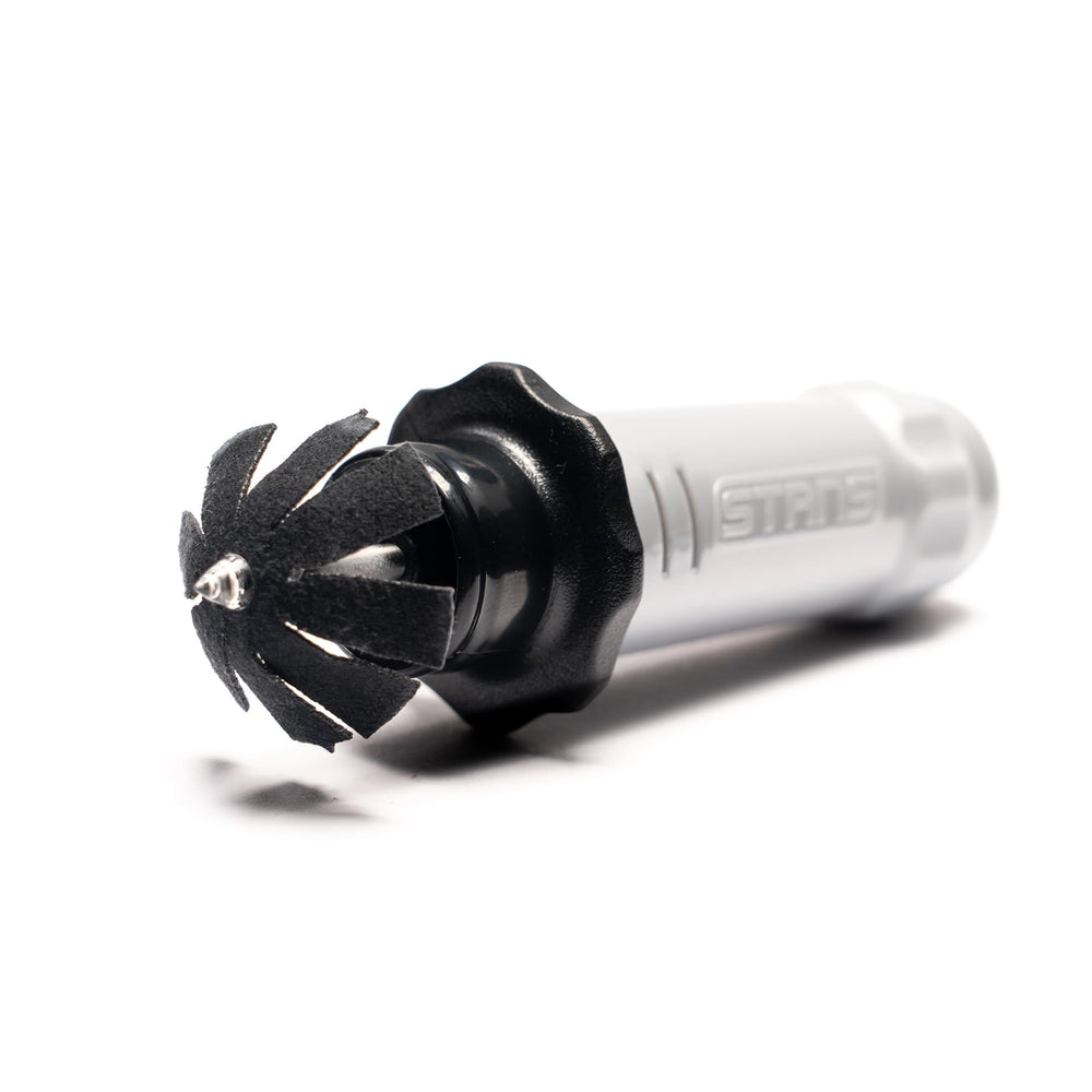 Stan's NoTubes DART next to coin for scale highlighting compact portability