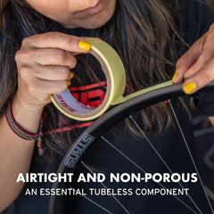 Stan's NoTubes rim tape next to a coin showing 21 mm width for correct sizing