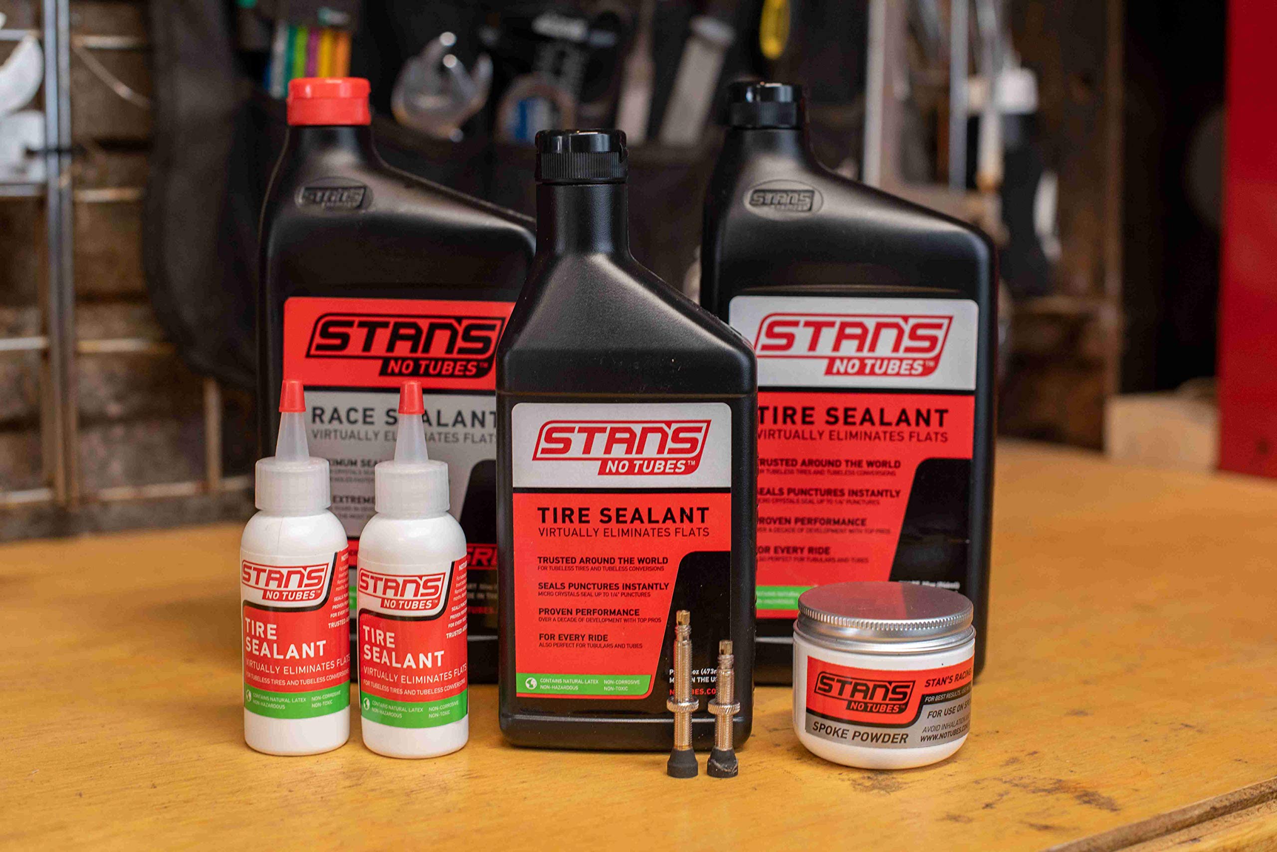 Stan's NoTubes bottle next to coin to show compact, travel-friendly size