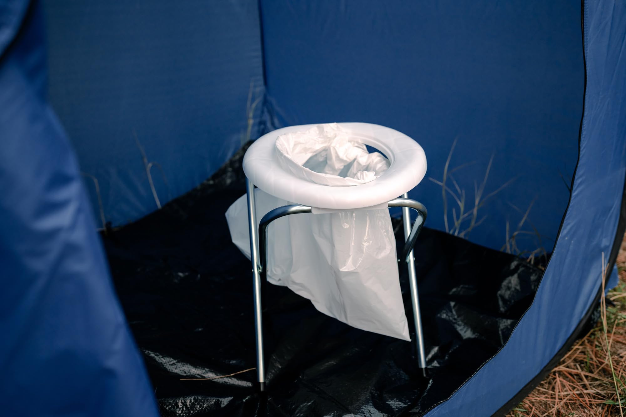 Stansport portable toilet in campsite setting offering convenient outdoor sanitation