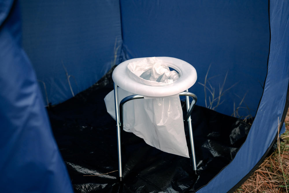 Stansport portable toilet in campsite setting offering convenient outdoor sanitation
