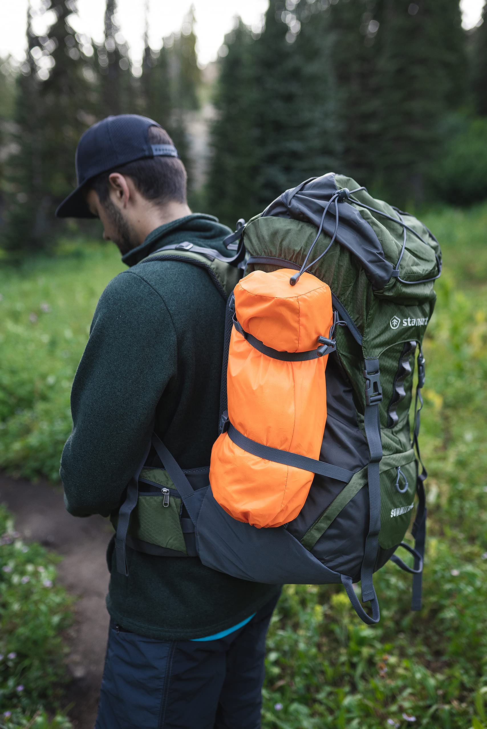 Stansport tent beside backpack for scale showing portable, packable design
