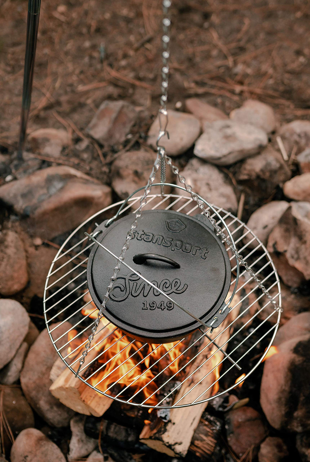 Stansport tripod over campfire with pot demonstrating stable cooking benefit