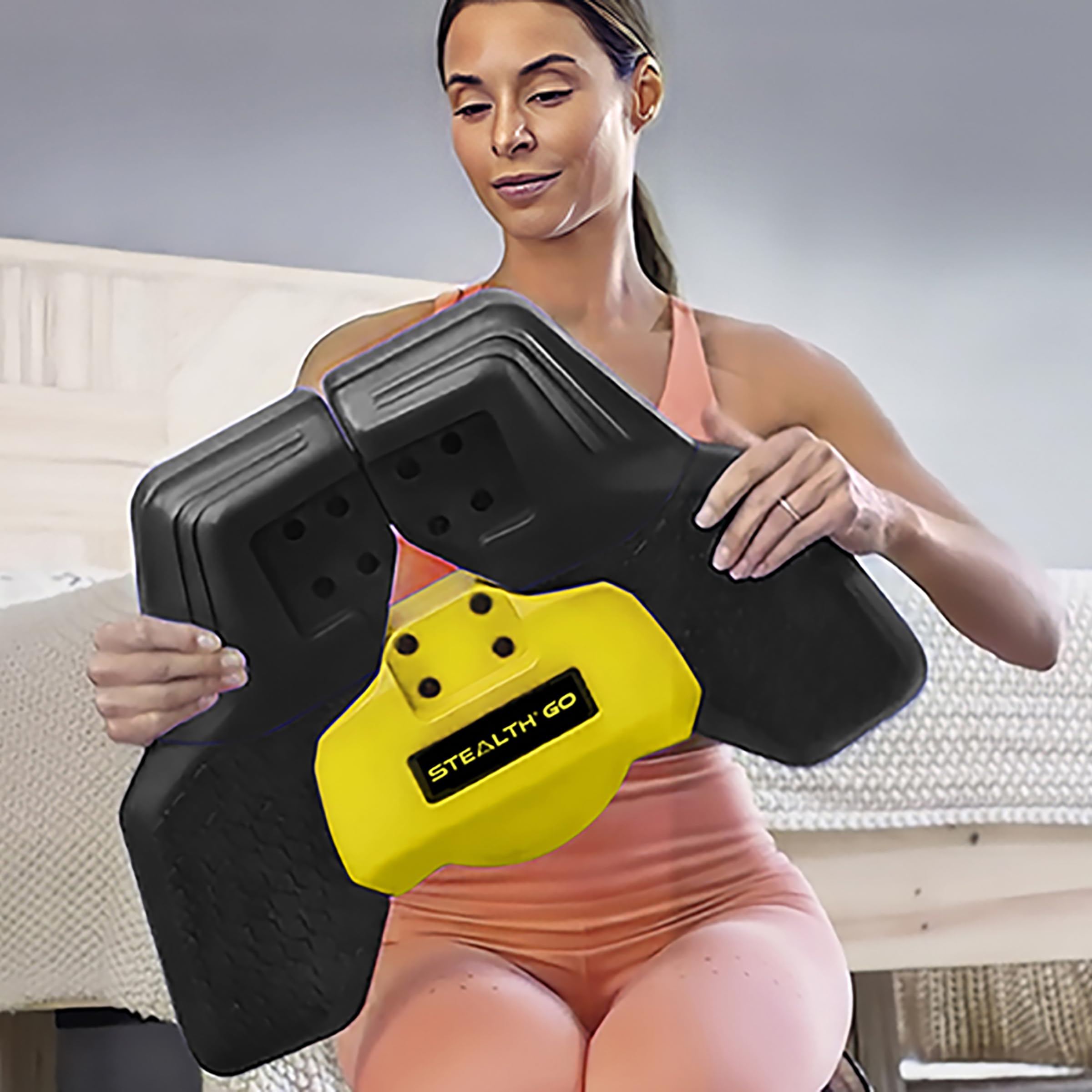 Stealth Fitness StealthGO next to water bottle showing compact size and easy storage benefit