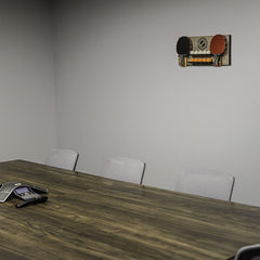 STIGA wall rack mounted in a game room creating organized, space-saving storage