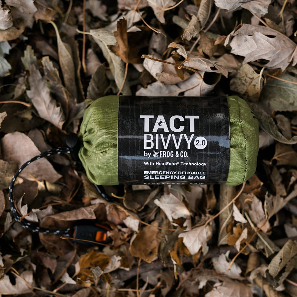 Survival Frog bright orange bivvy on trail aiding high-visibility rescue identification