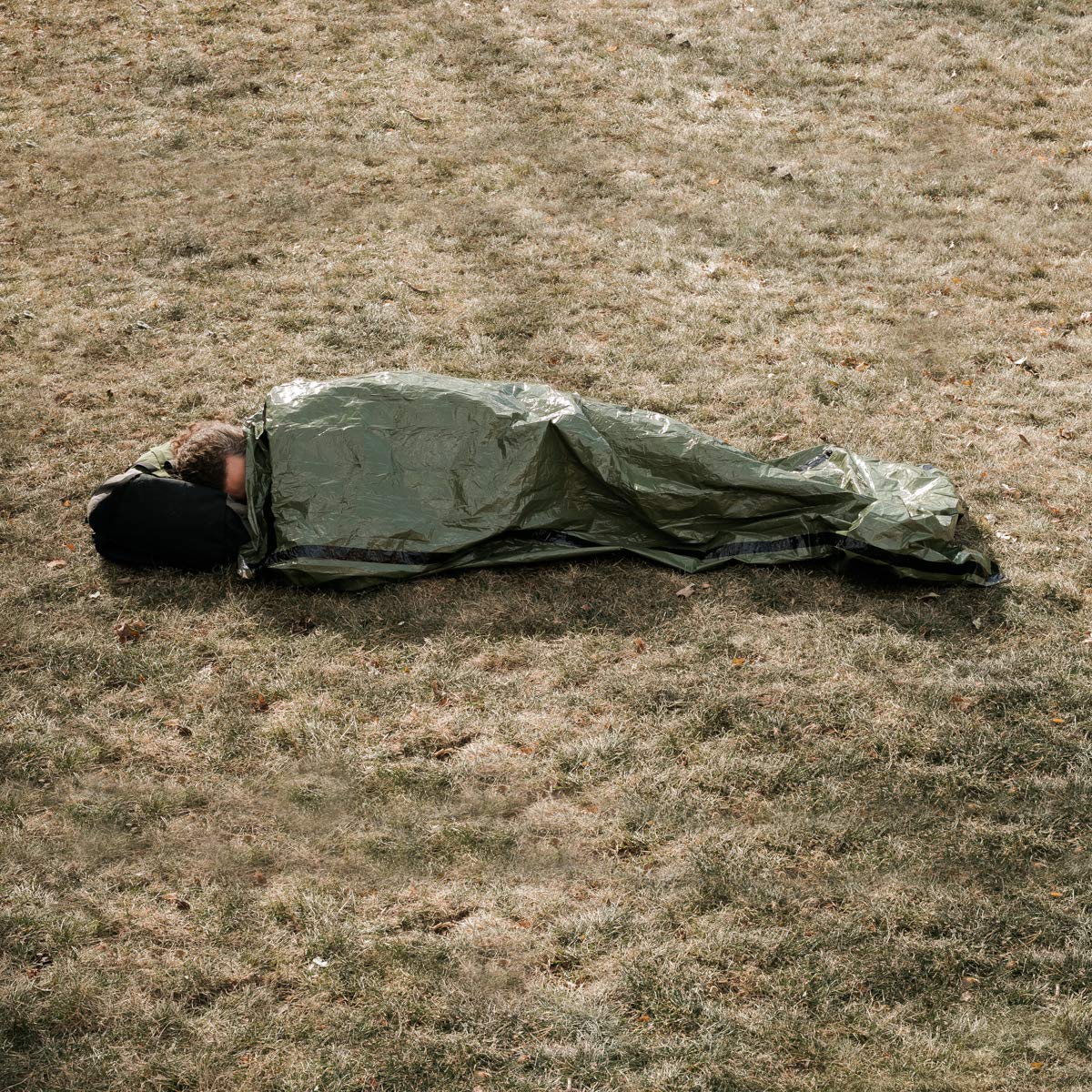 Survival Frog bivvy shedding water on rock demonstrating waterproof protection