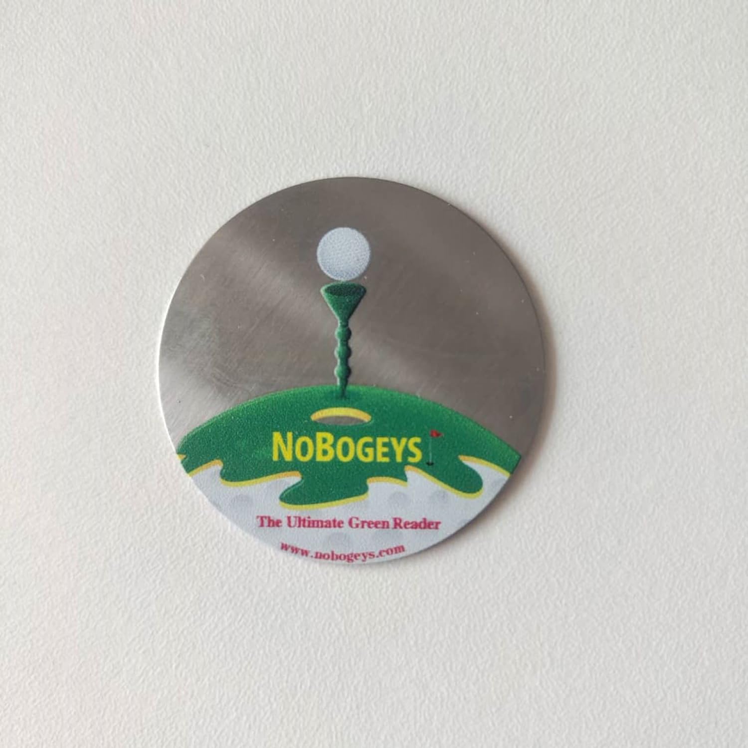 Tee Time Tees marker next to golf tee showing compact size benefit