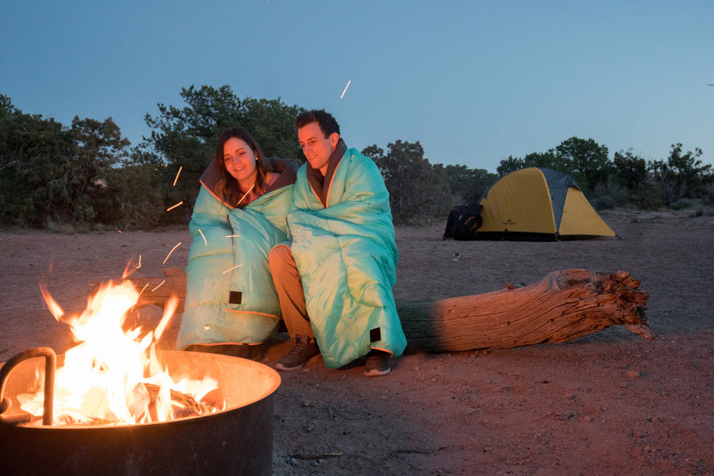 TETON Sports sleeping bag in included stuff sack beside backpack showing travel scale