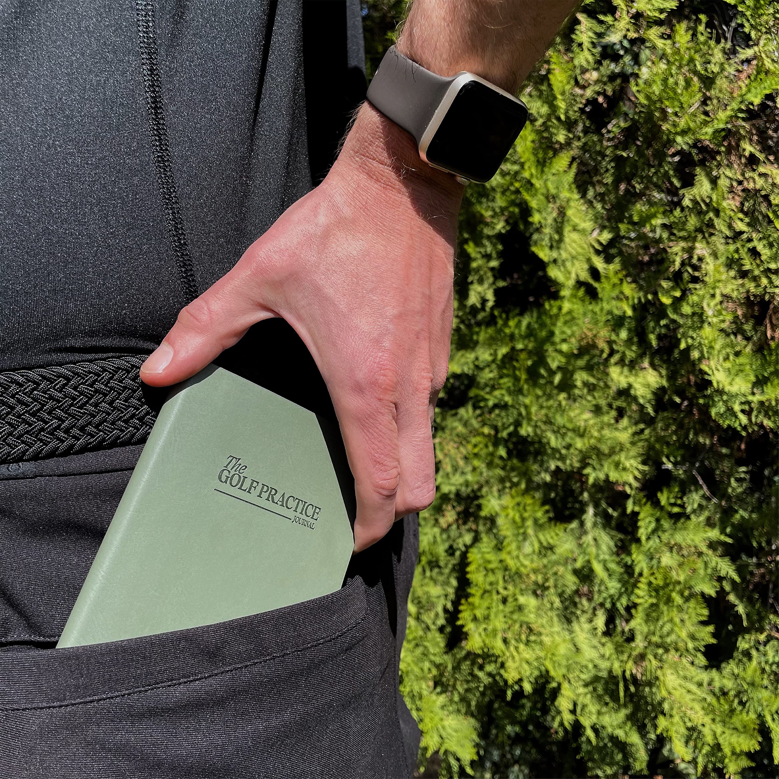 The Golf Practice Journal inside a golf bag showing quick access during rounds