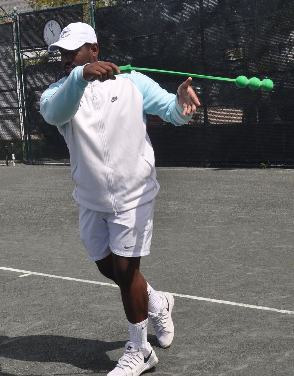 Size comparison with a tennis racket showing The Total Serve ServeMaster scale