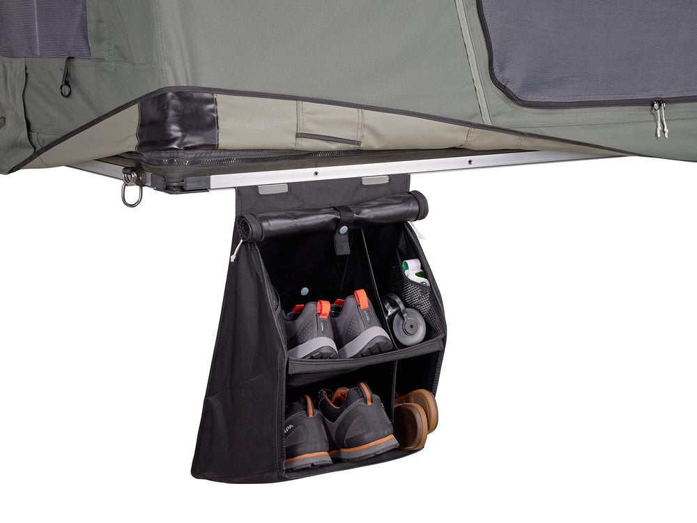 Thule organizer positioned near tent entrance for quick retrieval