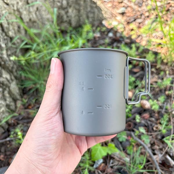 TOAKS cup held in hand conveying true-to-scale lightweight size and portability benefit