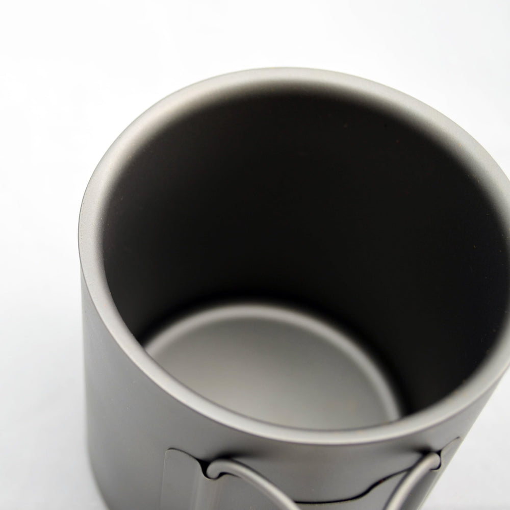 TOAKS cup filled with hot beverage illustrating double-wall comfort handling