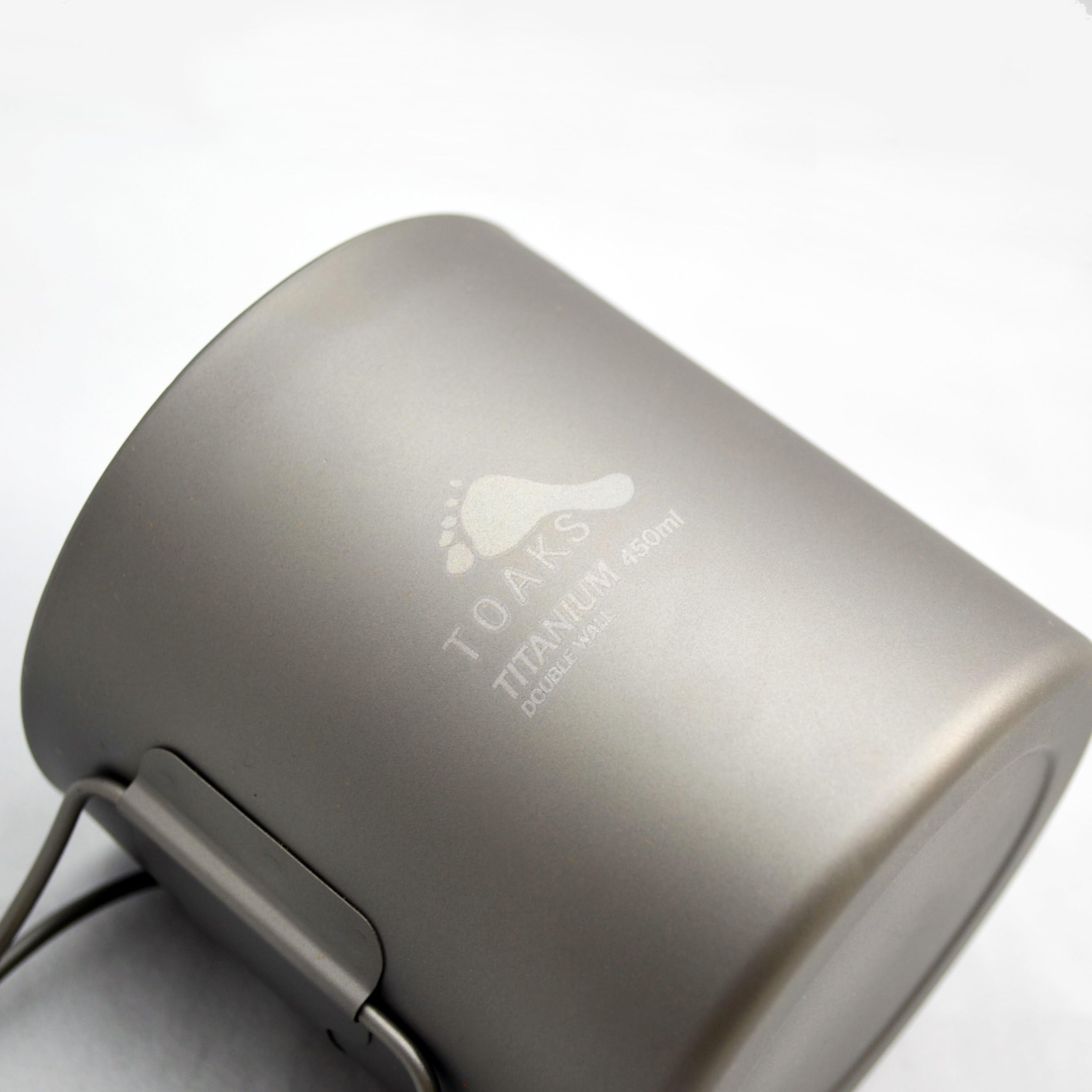 TOAKS cup held in hand to show size and lightweight benefit for packing
