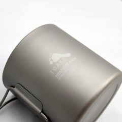 TOAKS cup held in hand to show size and lightweight benefit for packing