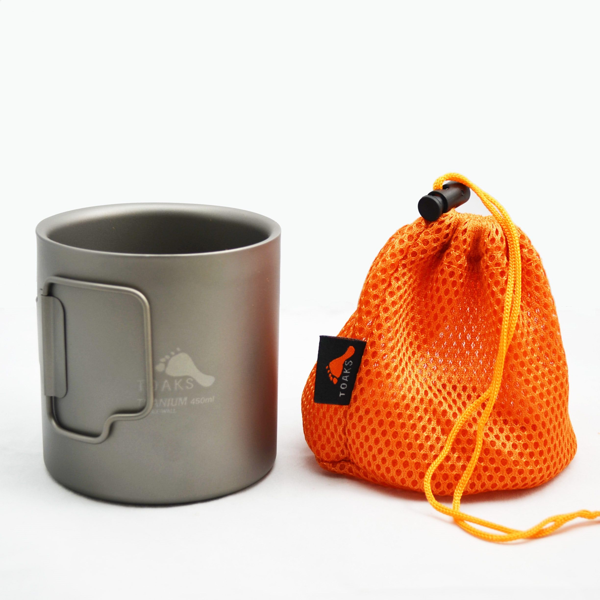 TOAKS cup on campsite table showing rugged outdoor utility and convenience
