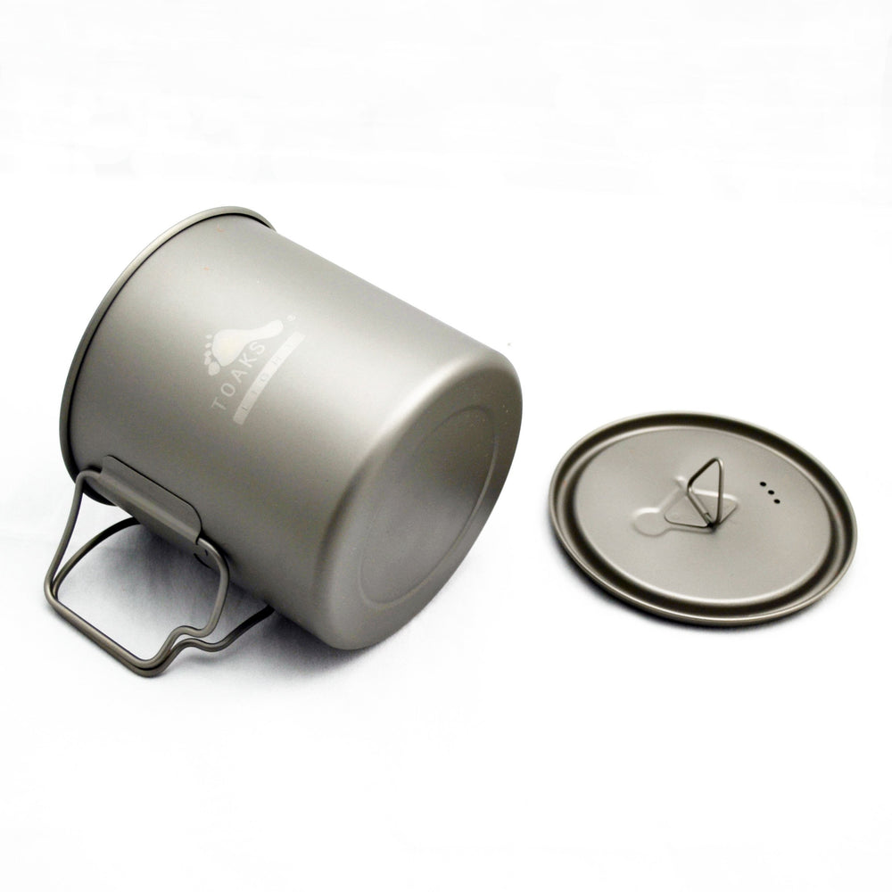 TOAKS titanium 650ml pot held in hand to demonstrate scale