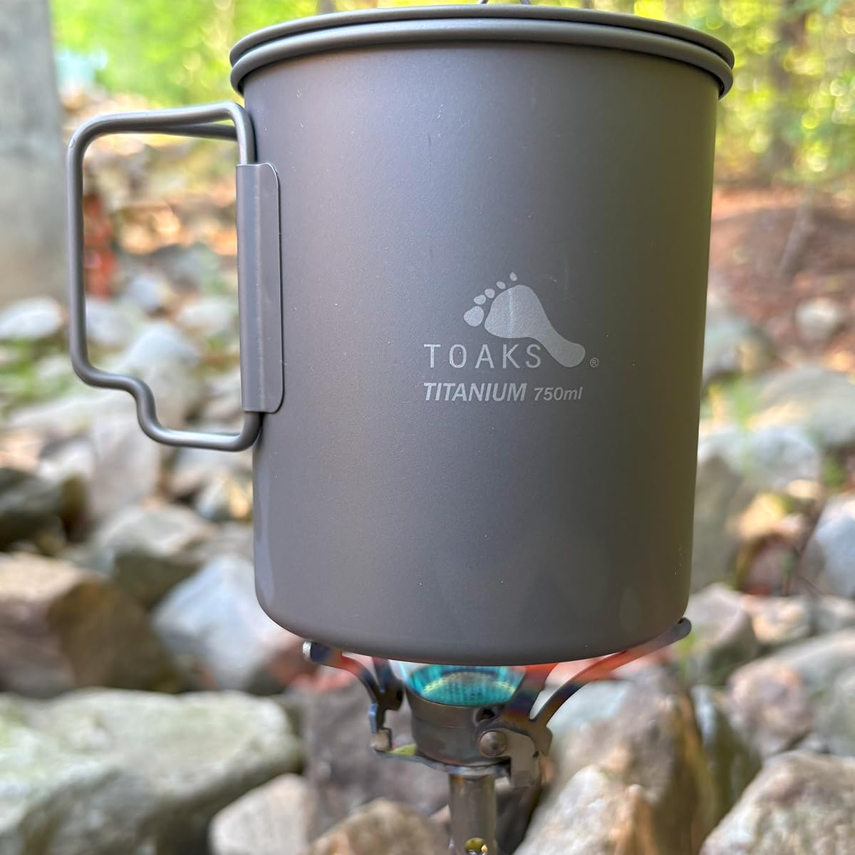 TOAKS titanium stove next to fuel canister showing scale and lightweight advantage