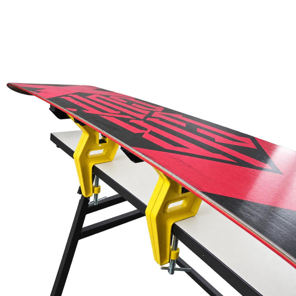 TOKO mounted on snowboard providing steady support for base work