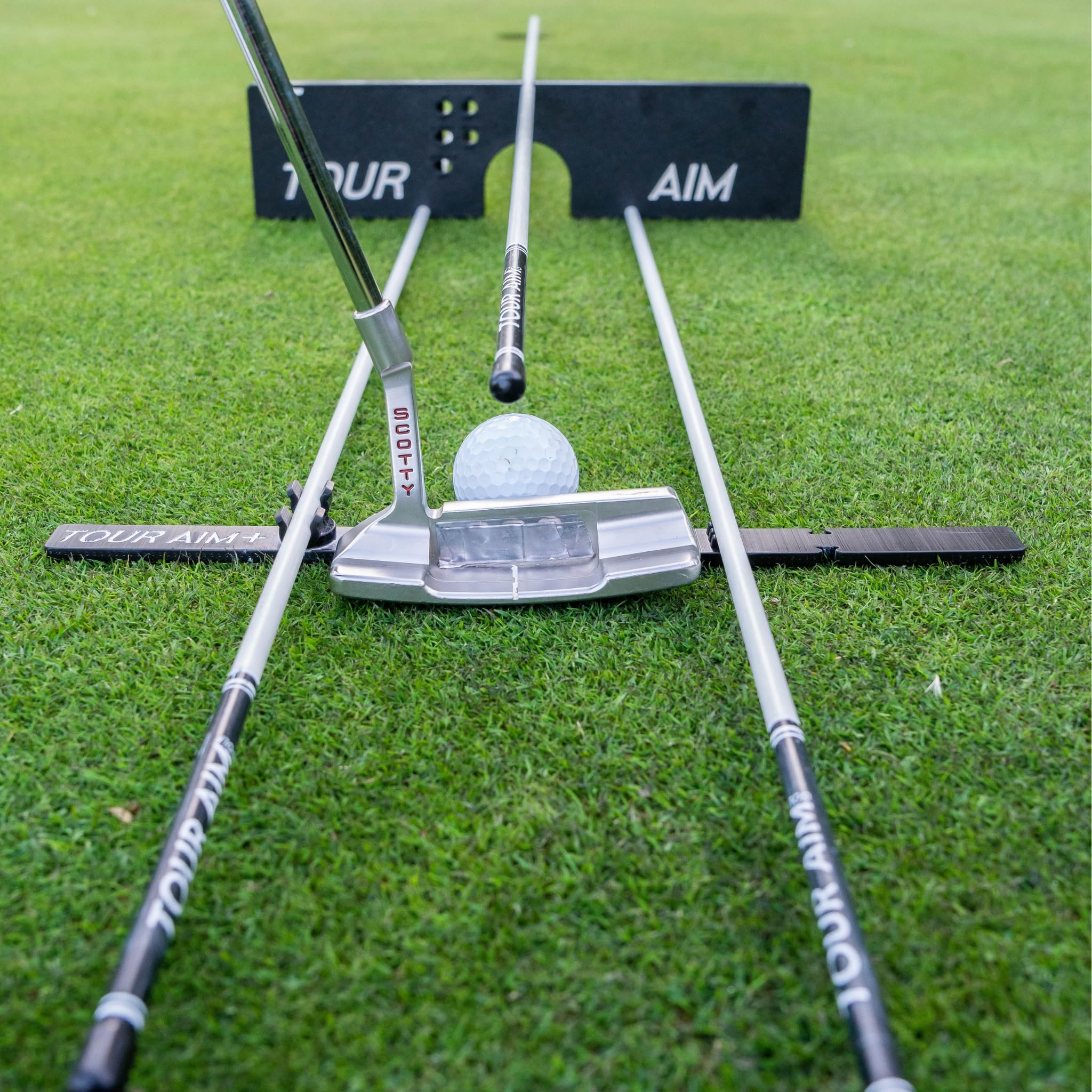 Tour Aim next to a driver for scale showing compact training portability