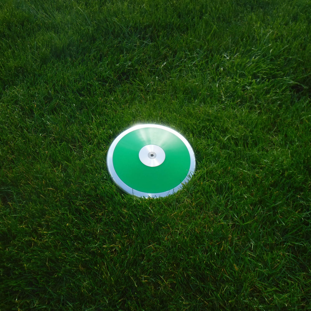 Trail Creek discus held in hand for size and scale comparison aiding proper grip development