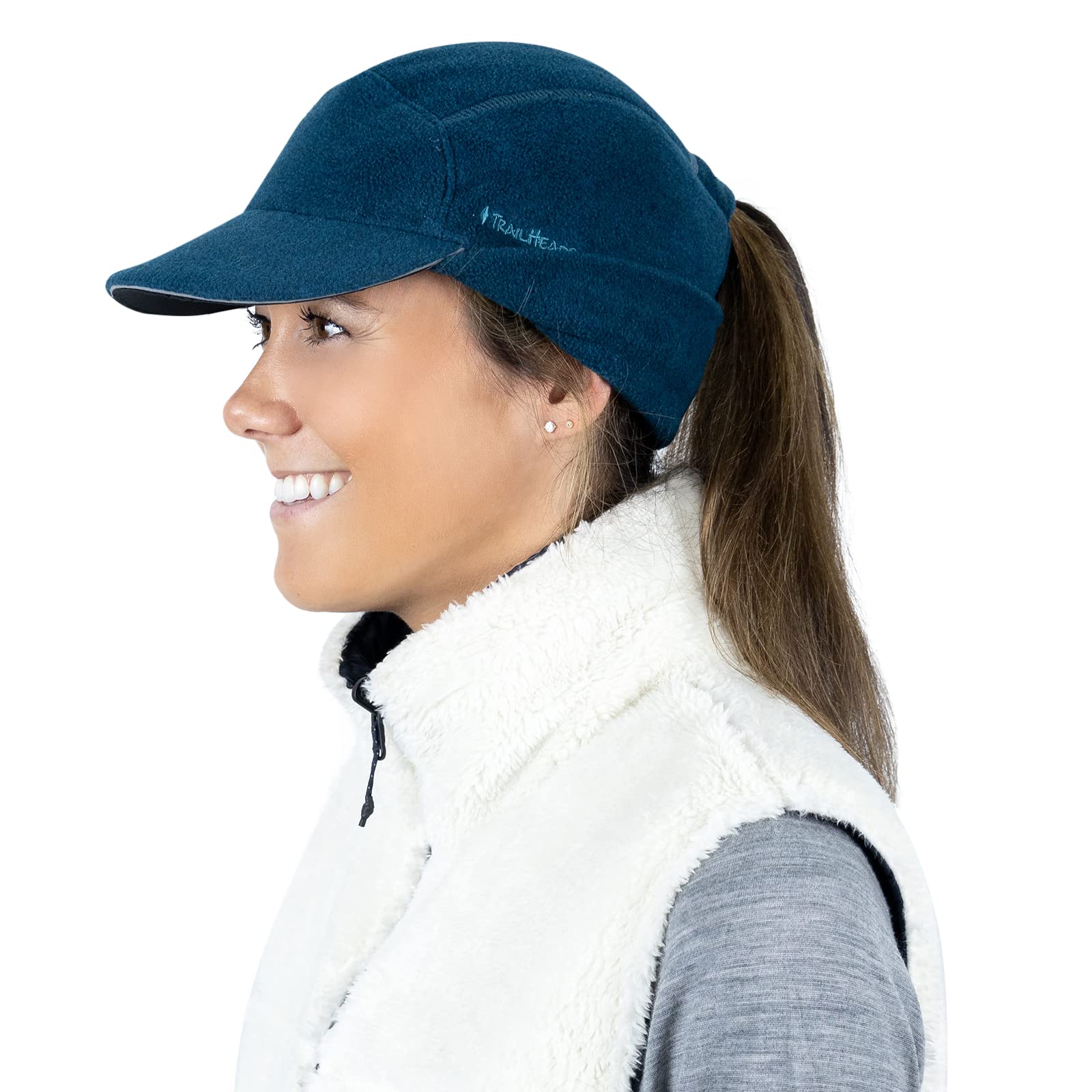 TrailHeads hat next to hand showing scale and low-profile fit for active wear