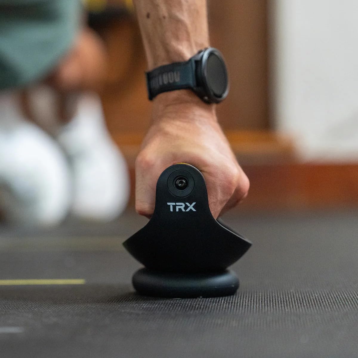 Home gym lifestyle scene with TRX Push-It supporting versatile workouts benefit