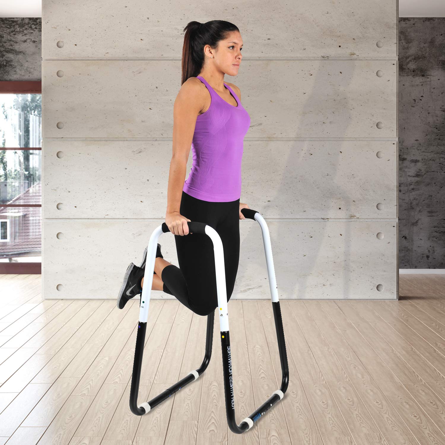 Ultimate Body Press performing knee raises showing core strengthening benefit