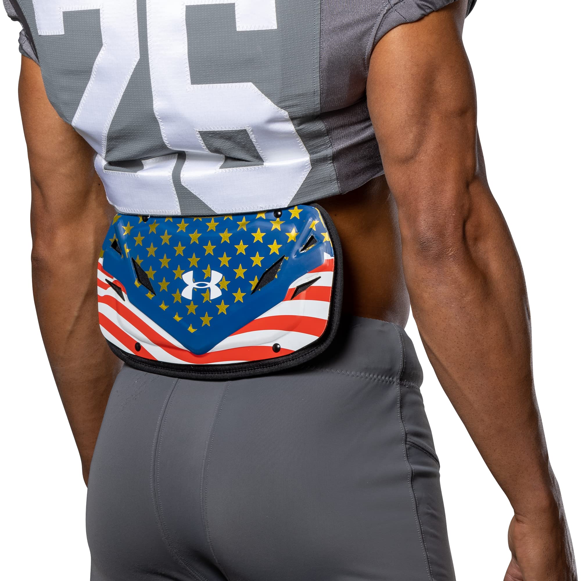Under Armour back plate next to ruler showing size options for correct fit