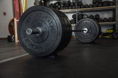 Vapor Fitness wedge positioned under barbell keeps bar steady during loading