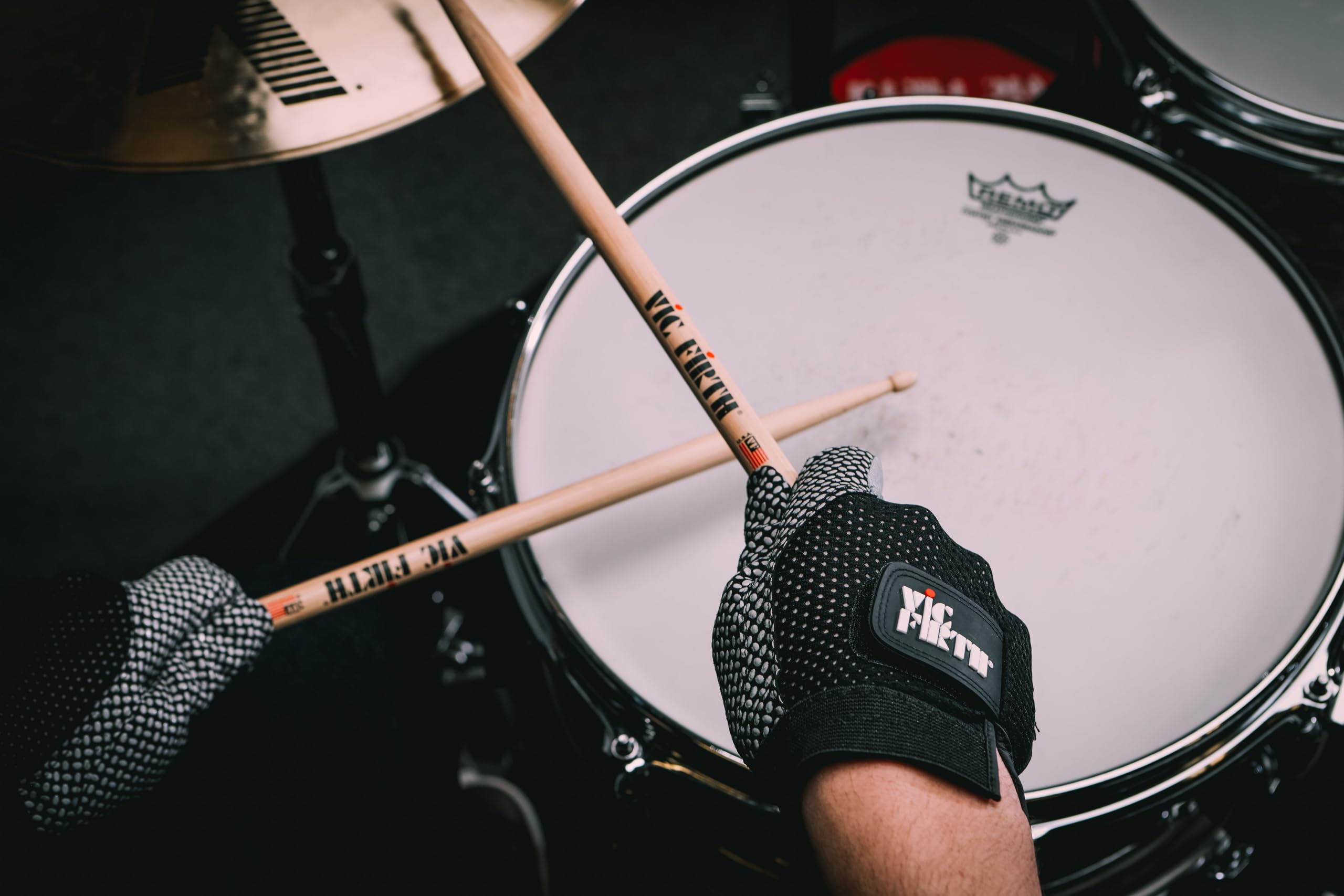 Vic Firth glove size scale with drumstick for accurate small fit and proportion reference