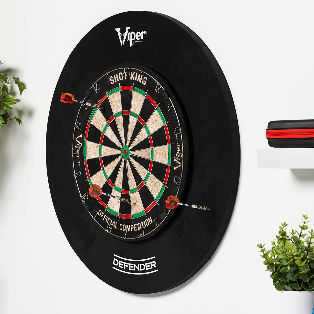 Viper by GLD Products player throwing darts with surround protecting wall