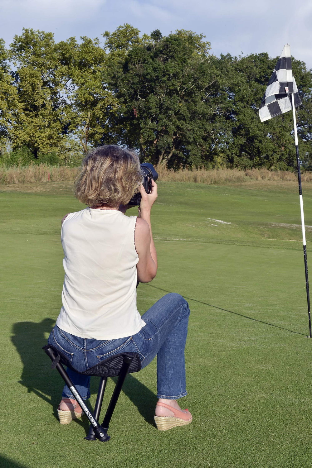 Walkstool on uneven ground demonstrating three-leg stability and support