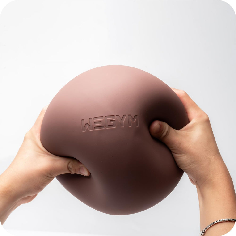 WeGym pilates ball in use demonstrates core activation during bridge exercise