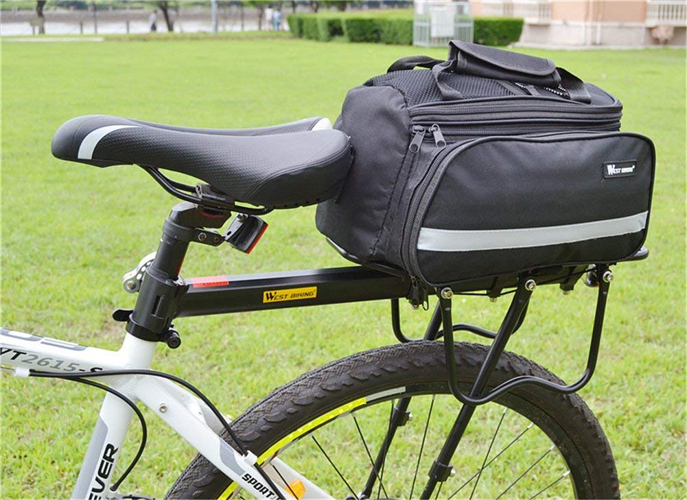 West Biking next to bicycle wheel for scale to ensure correct sizing before buy