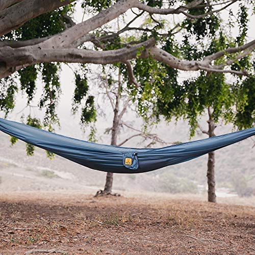 Wise Owl Outfitters hammock laid with backpack and boots illustrating travel readiness