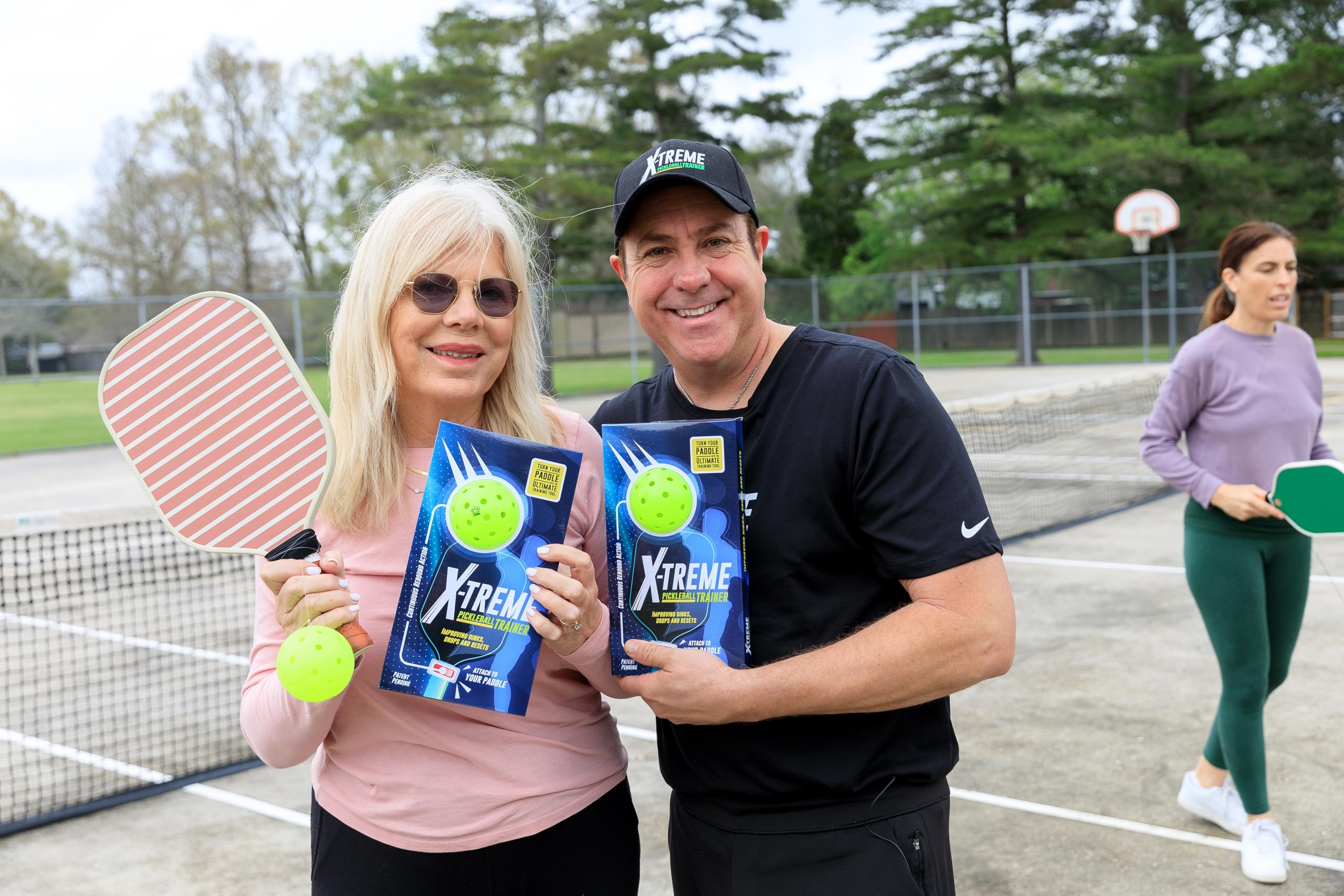 X-treme Pickleball Trainer next to paddle showing scale and easy transport