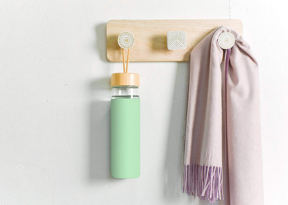 Yomious bottle held in hand showing compact 20 oz scale and convenience benefit